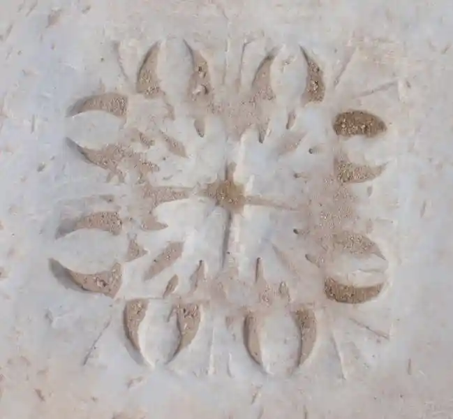 Cross inside a squarish solar disc engraved on marble stone in the ruins in Ephesus, Izmir